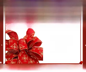 Detail showing red velvet Christmas bow with gold snowflake print and elegant textures