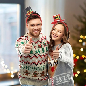 Close-up of festive Christmas headbands with mini top hats on models in a cozy holiday setting