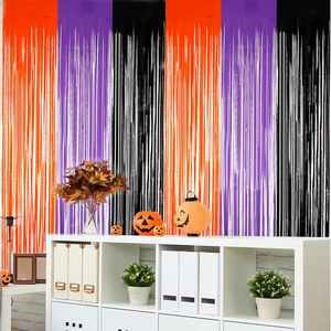 Close-up of Halloween tinsel curtain with orange purple and black metallic foil streamers