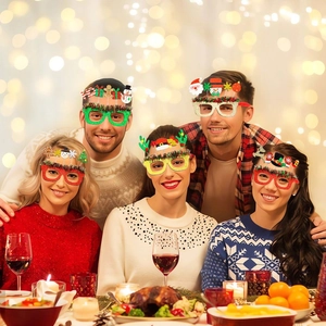 Group of friends wearing sparkling Christmas party glasses with festive holiday icons