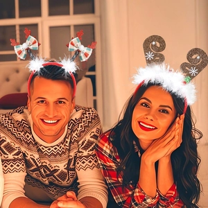 Detail of Christmas reindeer antler headbands with plush feathers and plaid bow accents