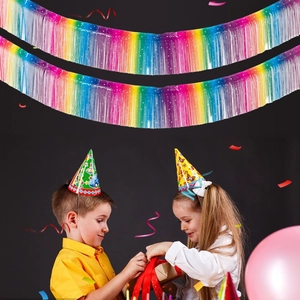 Rainbow foil fringe curtains background with kids opening gifts at a birthday party
