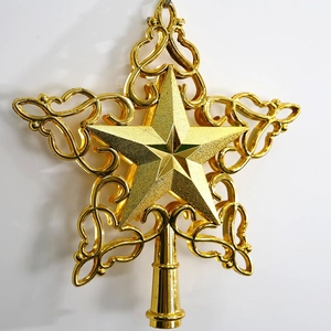 Detailed view of hollow gold star Christmas tree topper with ornate scrollwork patterns