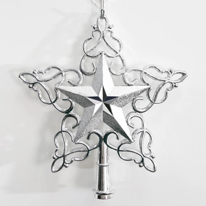 Close-up of silver hollow star tree topper with glitter finish and scroll patterns