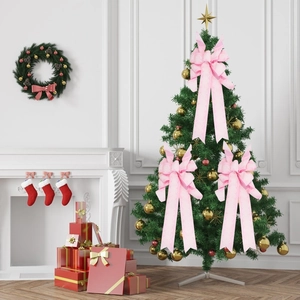 Three large pink glitter Christmas bows decorated on a festive wreath and tree