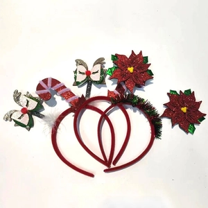 Close-up of Christmas headbands with reindeer antlers, candy canes and red flowers