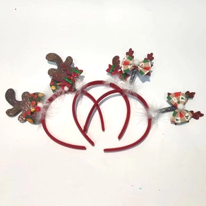 Detail showing glittery reindeer antlers and plaid bows on Christmas headbands