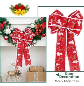 Detail of red velvet Christmas bow with gold reindeer and white tree prints for tree decor