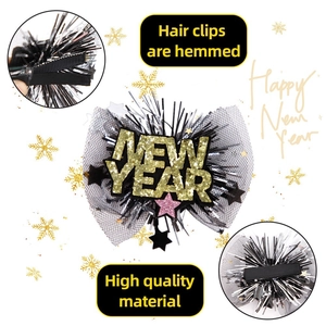 New Year party hair clip with gold glitter stars, mesh netting and feather detail