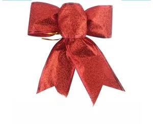 Detail of glitter red Christmas ribbon bow for festive tree and holiday decoration