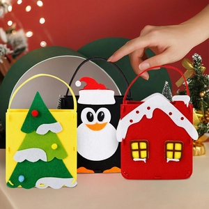 Three assorted Christmas felt gift bags featuring Santa, penguin and house designs