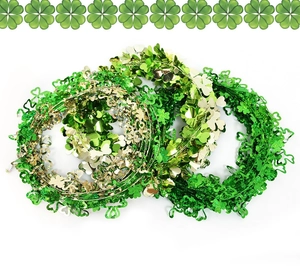 Close-up of three green and gold tinsel shamrock garlands for St. Patrick’s Day decoration