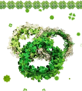 Detailed view of three St. Patrick's Day tinsel garlands with shamrock metallic leaf accents