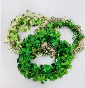 Close-up of Saint Patrick's Day shamrock wreaths in glitter green, light green and gold finish