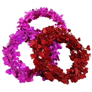 Red and magenta heart tinsel garlands for Valentine party decor on white background