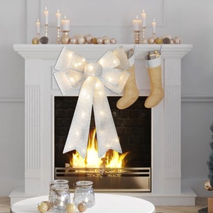 Detail of silver glitter LED Christmas bow with warm white lights for tree decoration