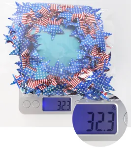 Weight measurement of Independence Day star garland showing 32.3g on a digital scale
