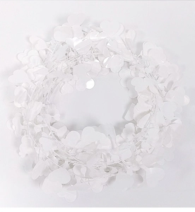 Detailed close-up of white heart-shaped leaf garland wreath for Christmas decor