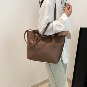 Minimalist brown leather tote bag for women with adjustable straps and spacious interior