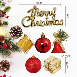 Christmas tree decoration set with gold Merry Christmas sign, red bells and mini gift boxes