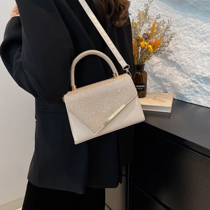 Elegant white leather crossbody bag with sparkling rhinestone flap and gold metal trim