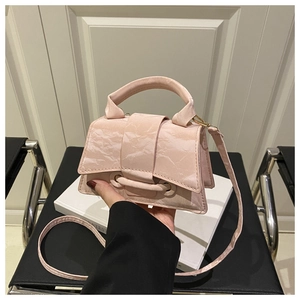 Detail of light pink mini crossbody bag with unique marble texture and elegant handle