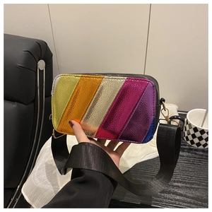 Detail of colorful metallic crossbody bag with textured stripes and wide fabric strap