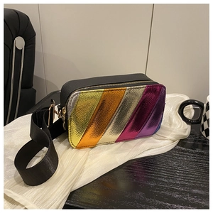 Detailed close-up of the colorful striped metallic patchwork on the black leather bag
