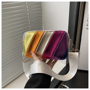Detail of colorful metallic striped crossbody bag with wide white nylon shoulder strap