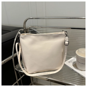 Détail du sac cabas minimaliste crème avec boucle en métal noir et bandoulière réglable