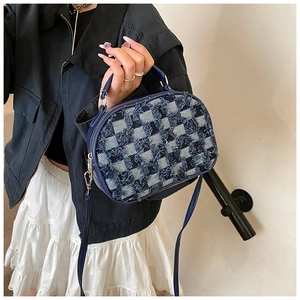 Détail du sac bandoulière en denim bleu à carreaux avec franges et boucles argentées