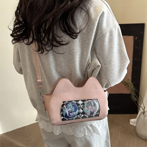 Pink cat-ear crossbody bag with a clear window and star pendant shown on model