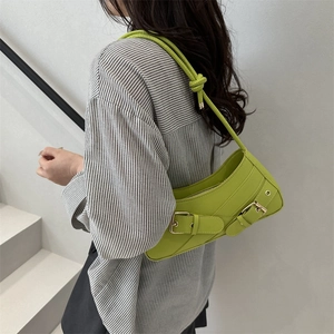 Chic lime green underarm baguette bag with metallic buckles and knotted strap detail