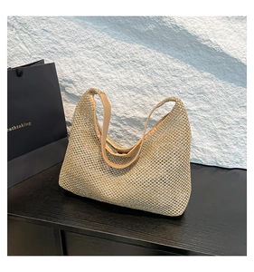 Gros plan sur le tissage doré d'un sac Hobo avec une bandoulière chic en similicuir
