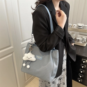 Light blue woven chain tote bag with cloud charm for casual college and commuting