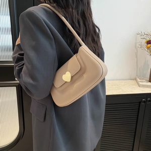 Beige minimalist crossbody bag with heart-shaped gold buckle for women in 2025 style