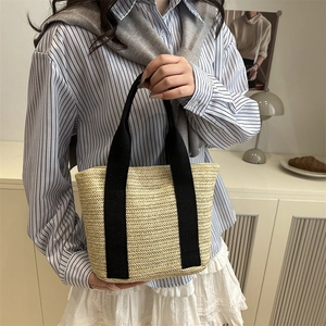 2025 trendy hand-woven straw bucket bag with black canvas handles for women's summer leisure