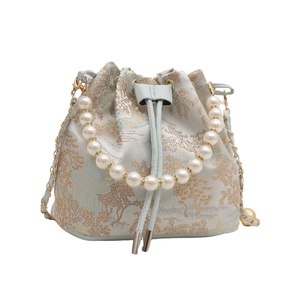 Elegant light blue jacquard bucket bag with pearl handle and golden chain strap