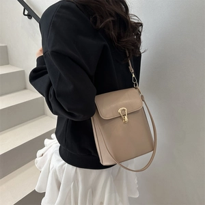 Sac seau chic en cuir beige avec boucle fer à cheval dorée élégante pour femme