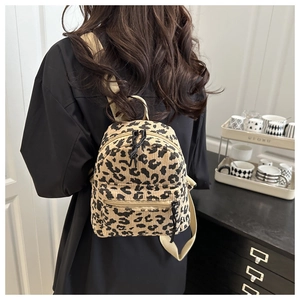 Detail of trendy leopard print mini backpack with corduroy texture and adjustable straps