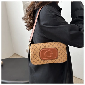 Macro detail of monogram print underarm bag with vintage embossed G logo and leather strap