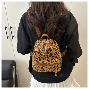 Leopard print corduroy backpack worn by a model to show actual size and fit