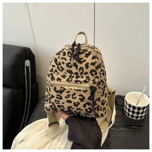 Detail of leopard print corduroy mini backpack showing soft texture and zippered pocket