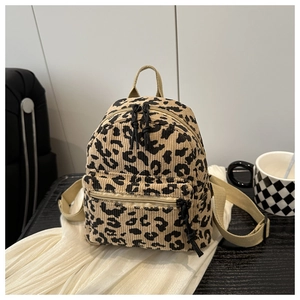 Mini leopard print backpack in beige corduroy with textured zipper pockets and straps