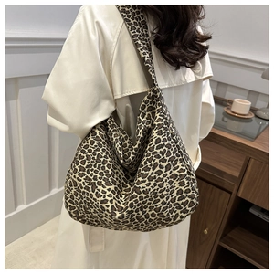 Detail of high-capacity leopard print canvas tote bag featuring retro hobo style design
