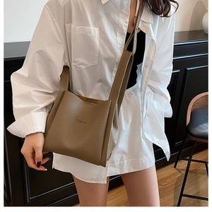 Detailed macro view of brown litchi pattern leather bucket bag with Fashion embossing
