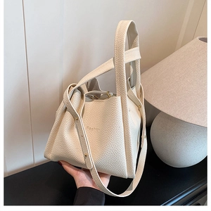 Close-up of litchi grain cream bucket bag with Fashion embossing and leather handle