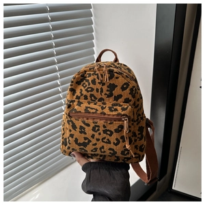 Detail of mini corduroy leopard print backpack with brown straps and zipper pockets