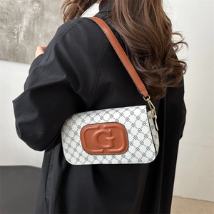Chic underarm bag with white diamond pattern and vintage brown leather G logo detail