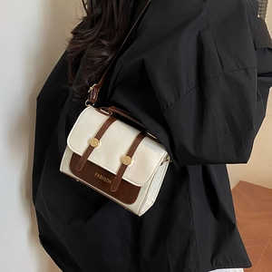 Minimalist cream and brown crossbody bag with gold buckle and fashion text detail
